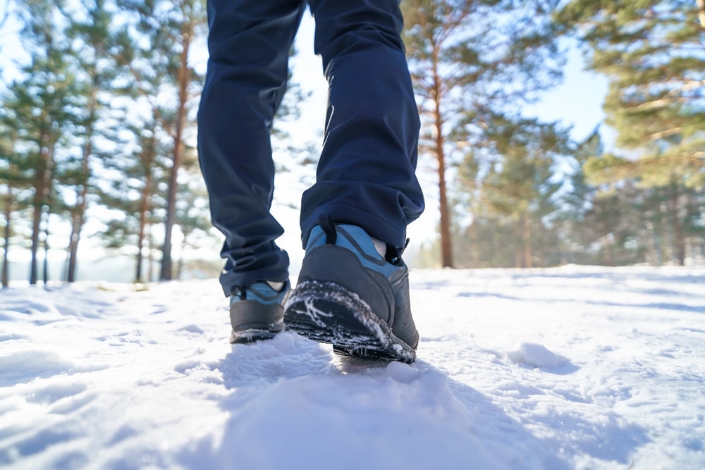 A back view of a person walking on snow