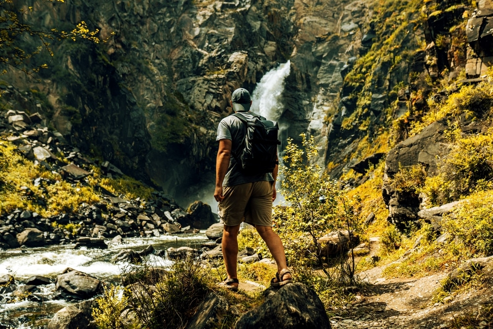 A backview of a person wearing hiking shorts on a trip