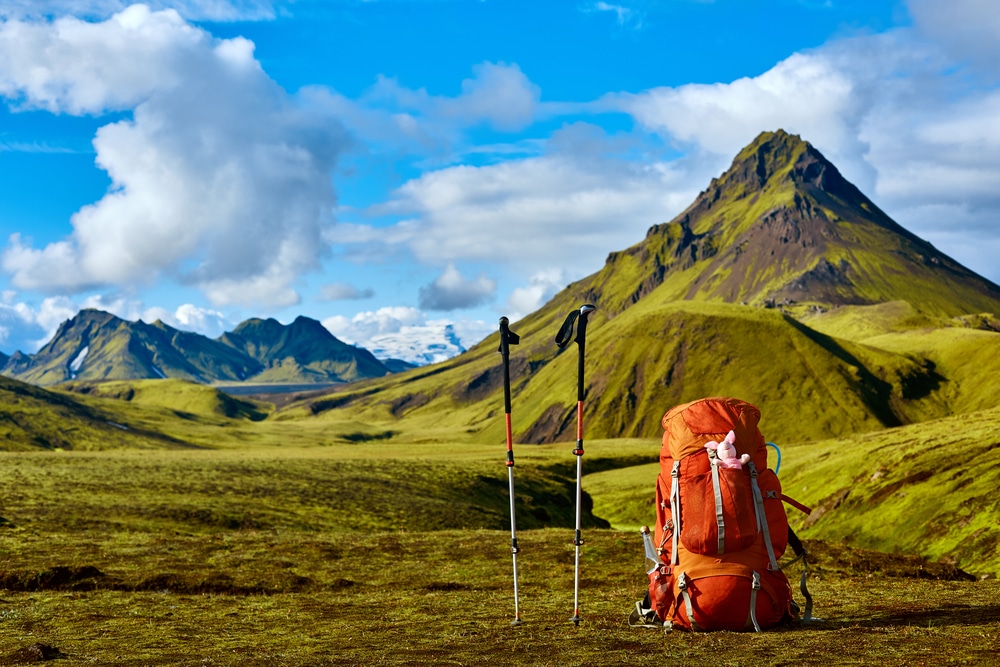 A view of a bagpack along with trekking poles