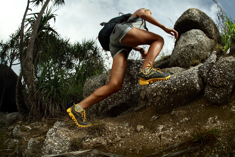 A view of a hiker climbing mountain with shoes on