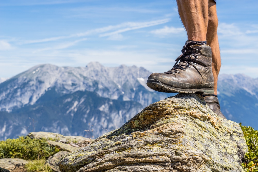 A view of a person with hiking shoes on a mountain shoes