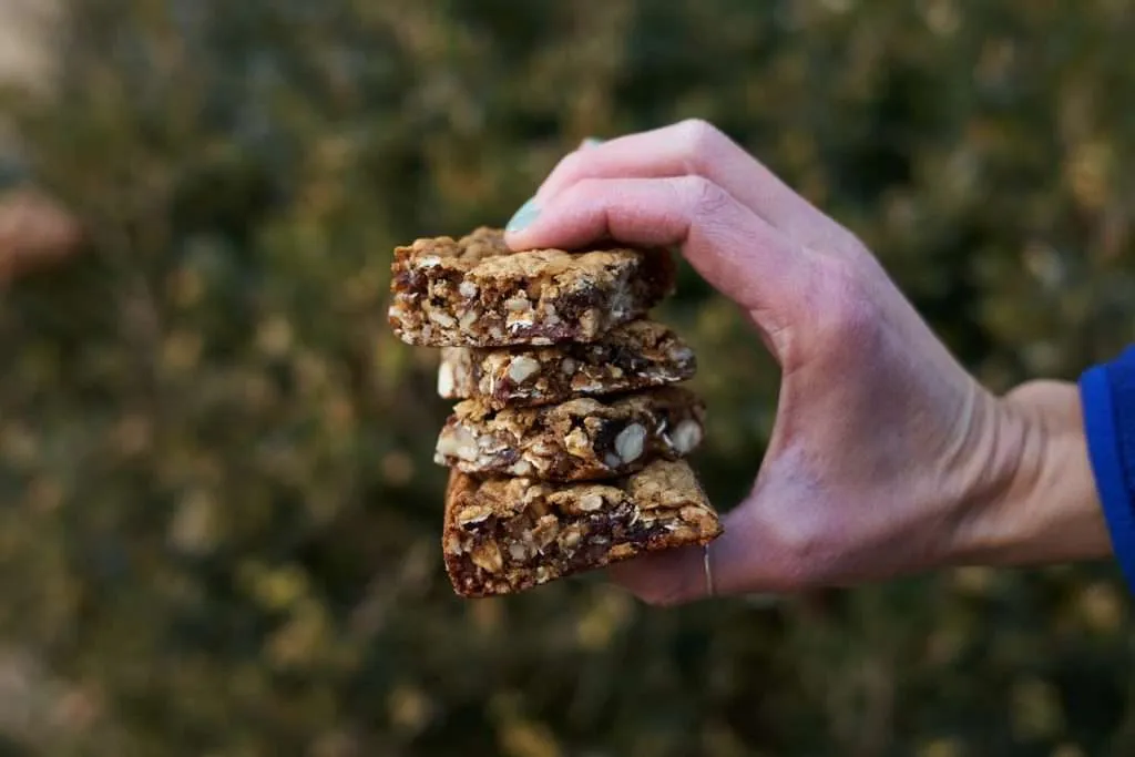 A person holding bunch of granola bars