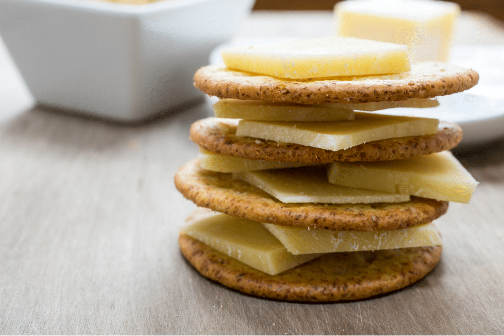 Crackers with cheese sliced on top of one another