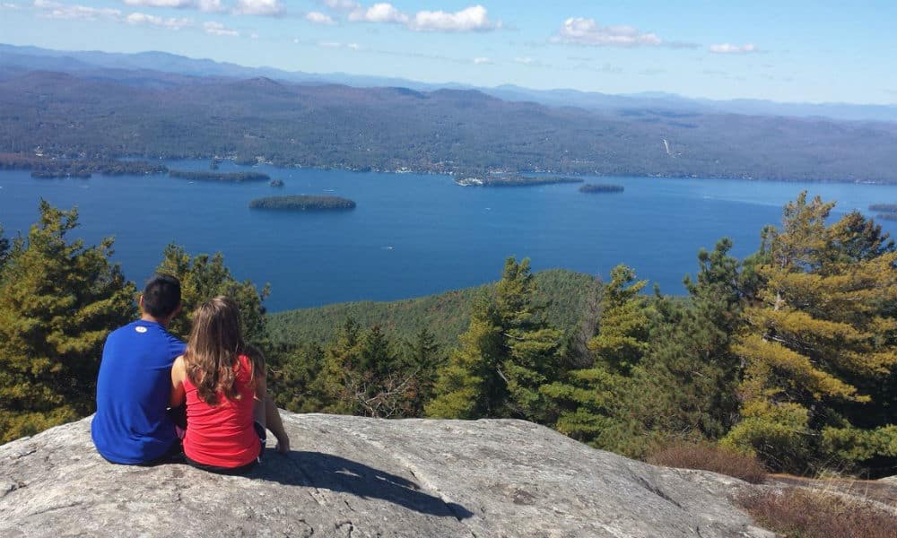 a boy and girl sitting on prospect mountain enjoying the scenic views