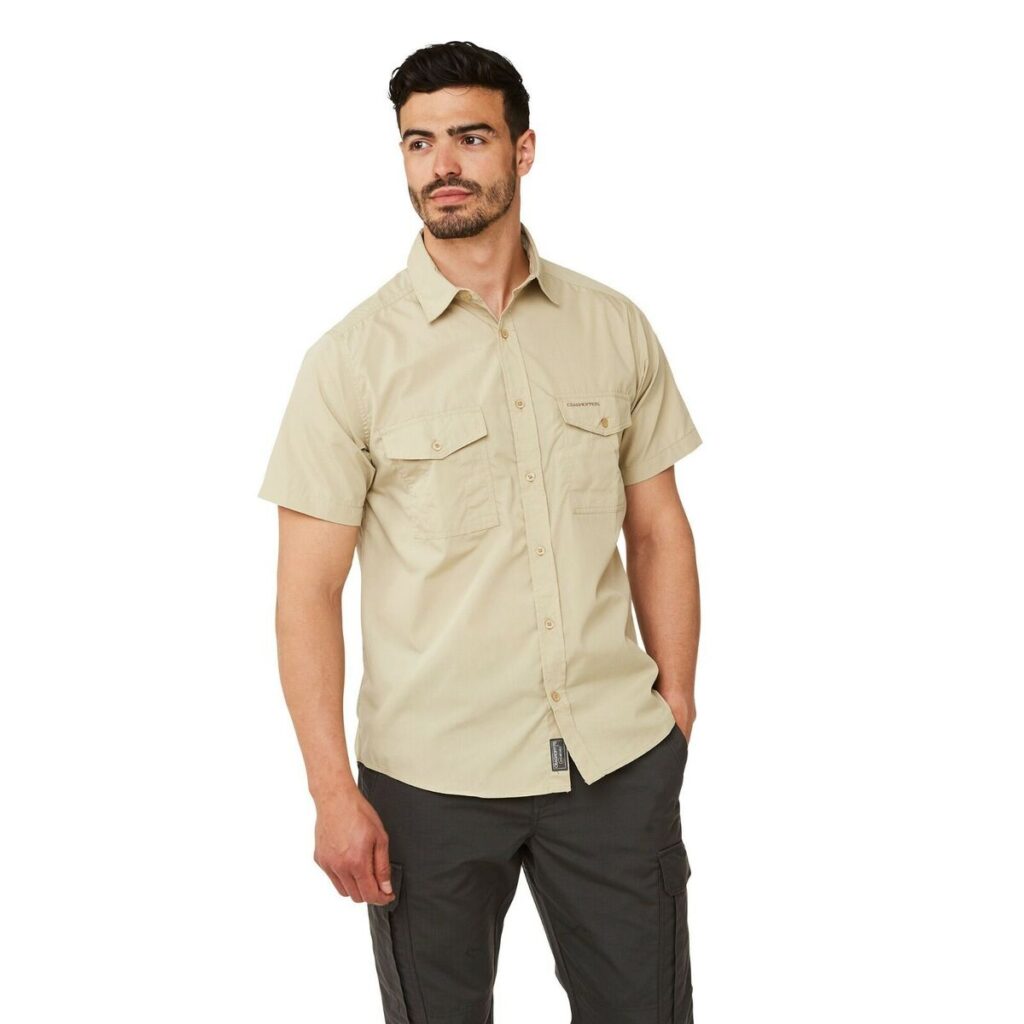 a boy wearing Craghoppers kiwi shirt in beige color