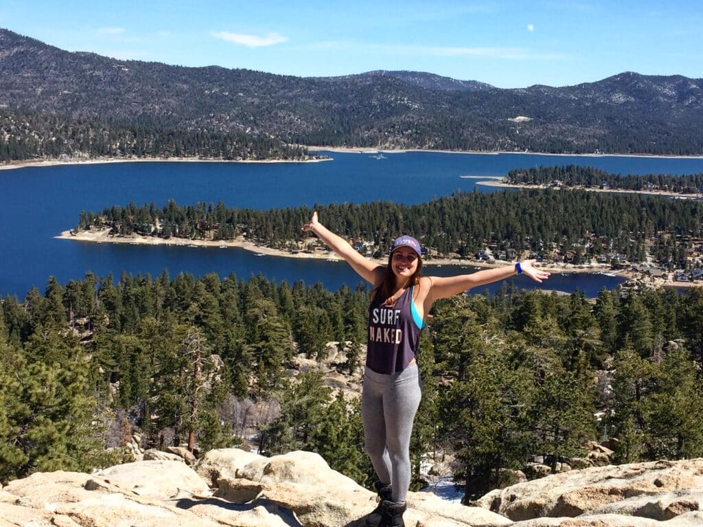 a girl standing on castle rock near big bear lake