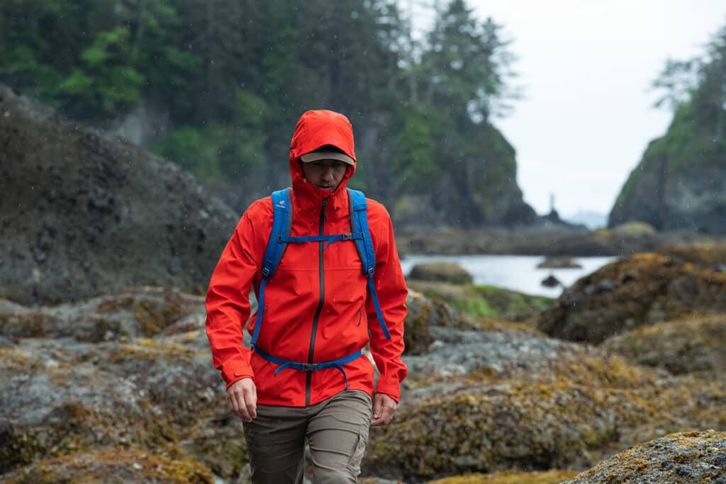 a person wearing red colored noth face jacket