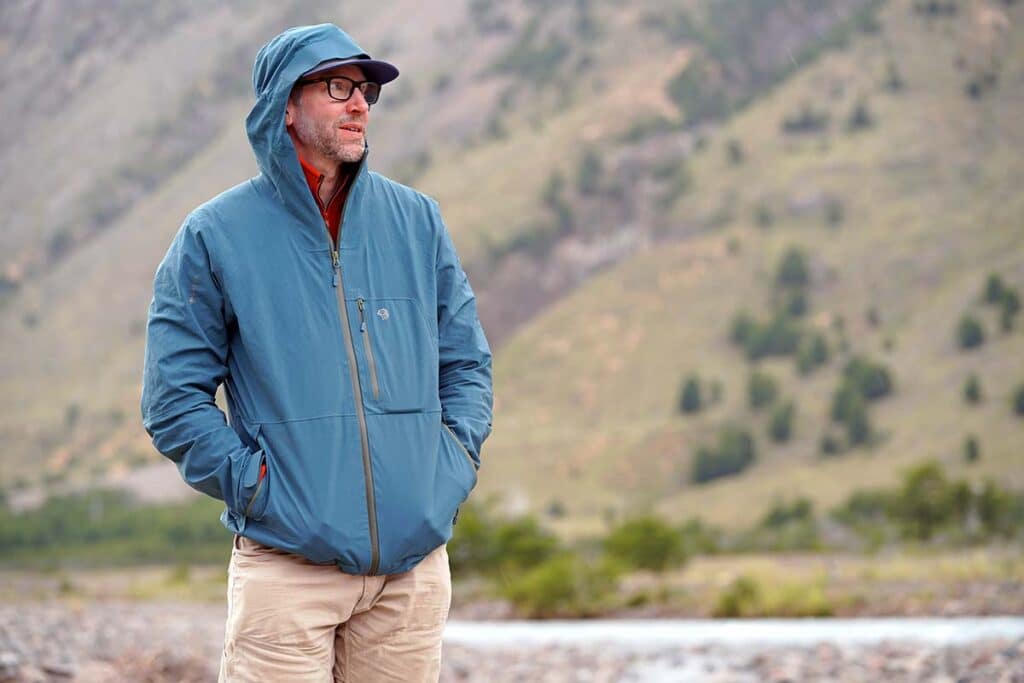 hiker wearing hardwear exposure hiking jacket in blue color