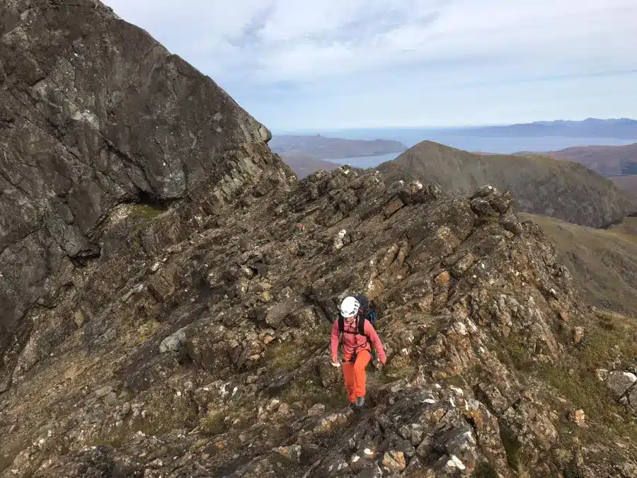 A female hiker navigating rough rocks