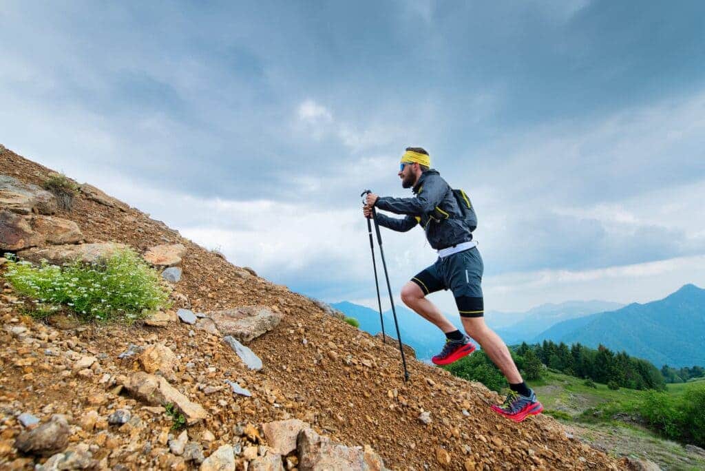 a male climbing a rocky path