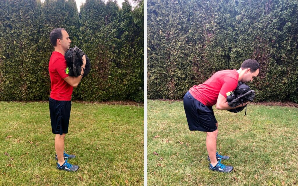 a man doing upper body training holding bag and standing in a lawn