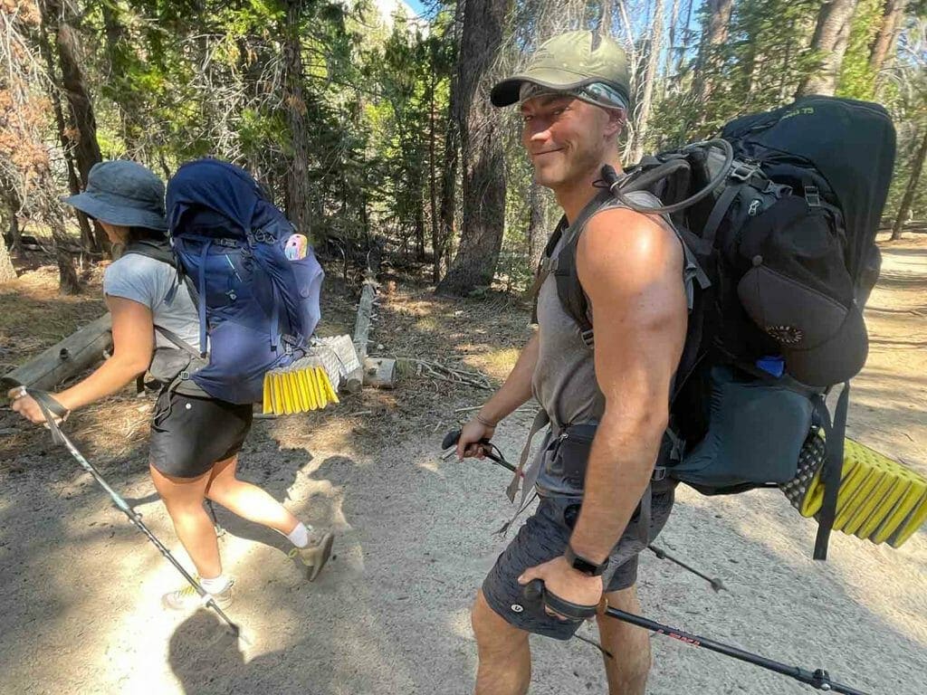 fit hikers trekking through forest