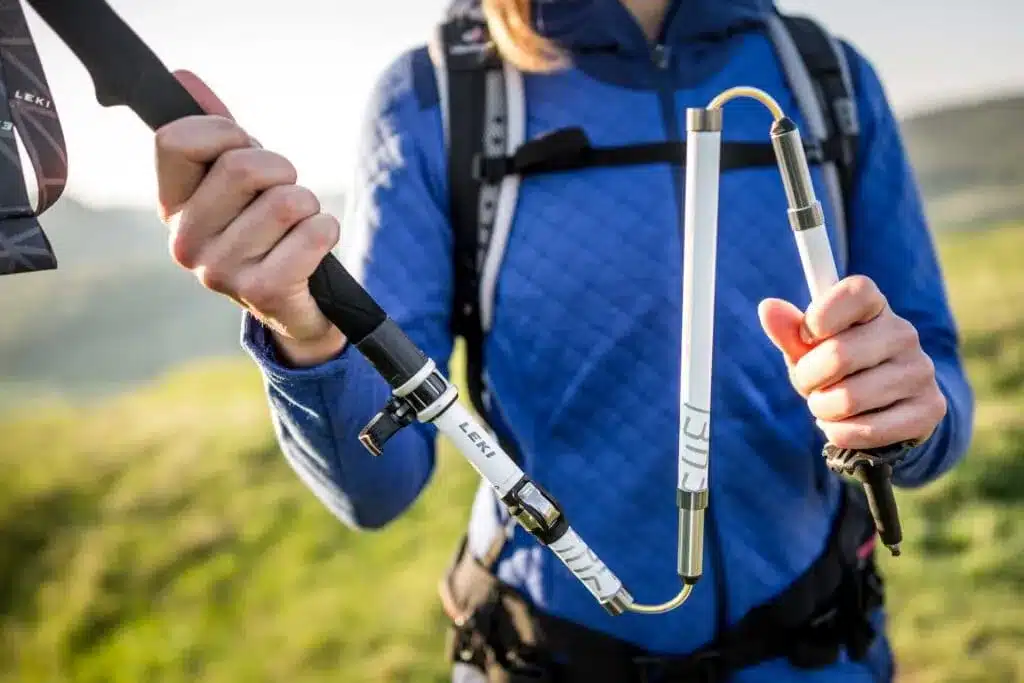 male hands adjusting the hiking pole length