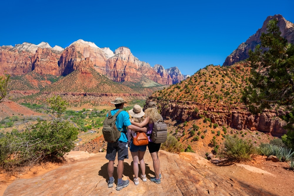 Family On Top Of The Mountain Enjoying Beautiful View On Hiking Tip In Utah 