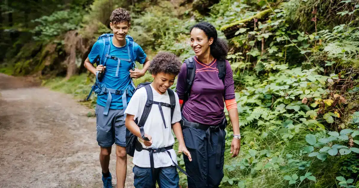 a girl kid and a boy happily walking through the path