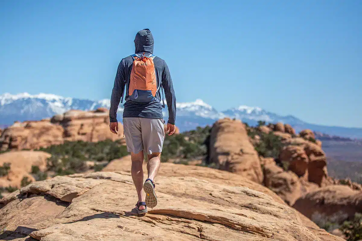 back view of a boy wearing shorts and a abckpack